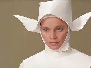 Curvy brunette with silicone lips posing for Erotic magazine