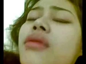 Sultry blonde on heels lies in bed and rubs her fingers in shaved kitty