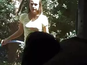 The guy tied his girlfriend's eyes and kicked her in the butt.