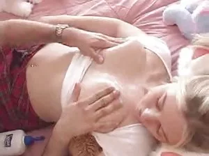 Skinny little girl with small breasts naked in bed