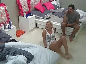 Mature woman in a cap puts a man's fingers in the ass